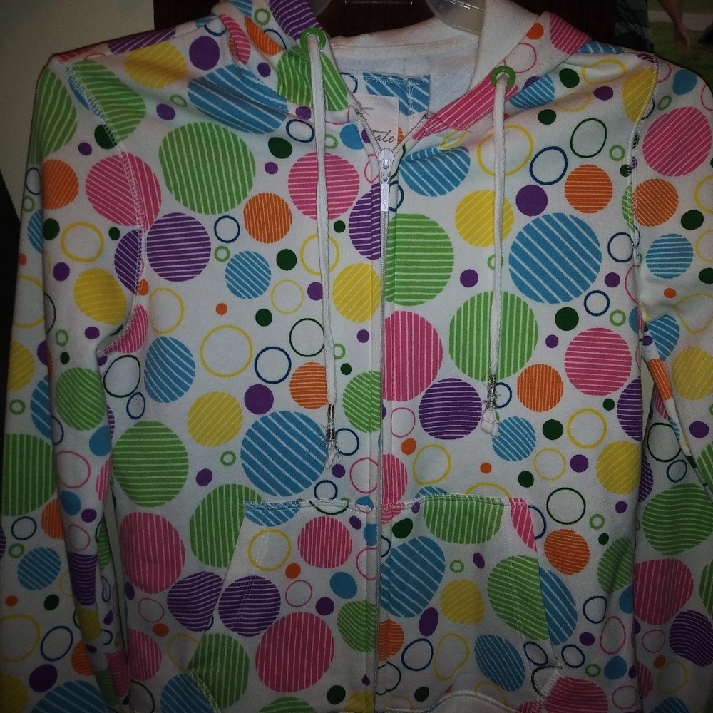 White with colorfully dots on it. Zips with hood